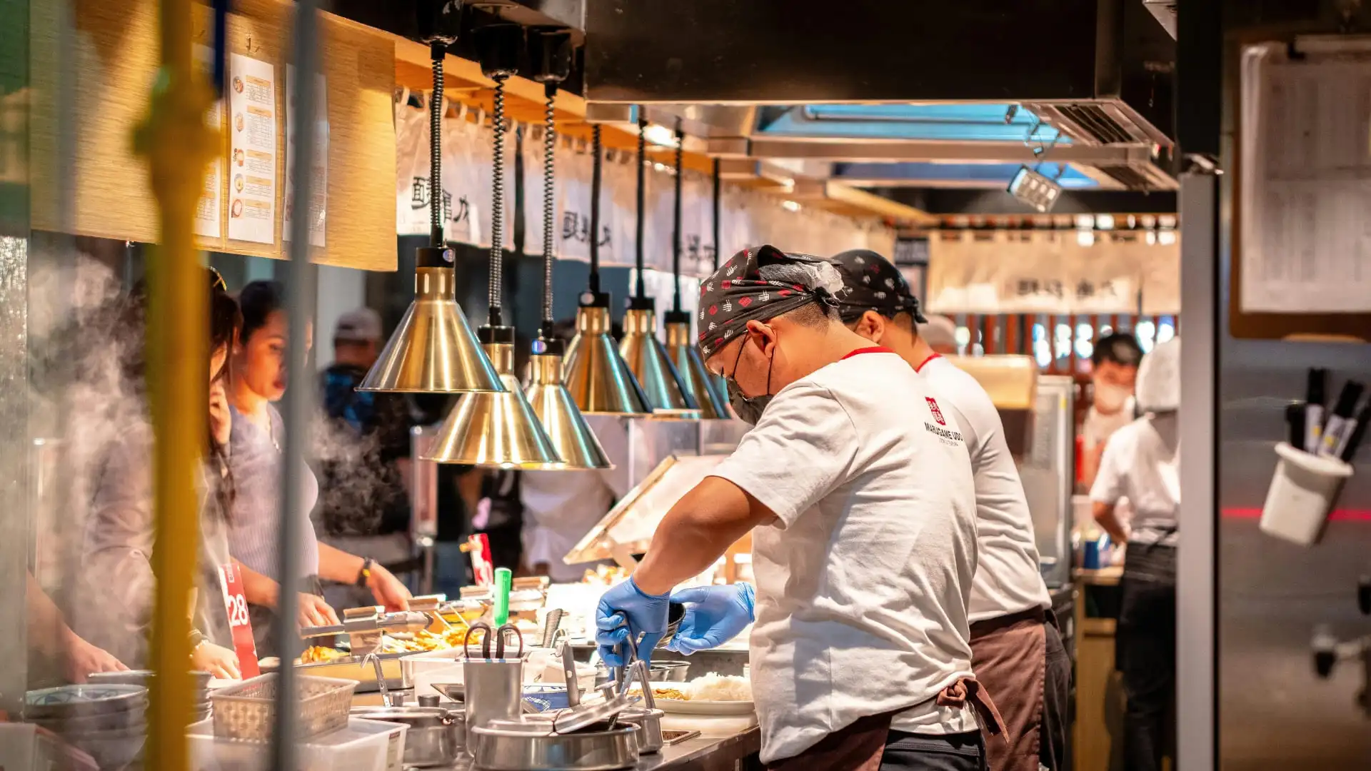 Kitchen staff working in an open restaurant kitchen